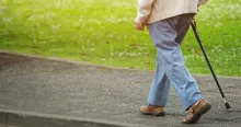 Person walking with cane 