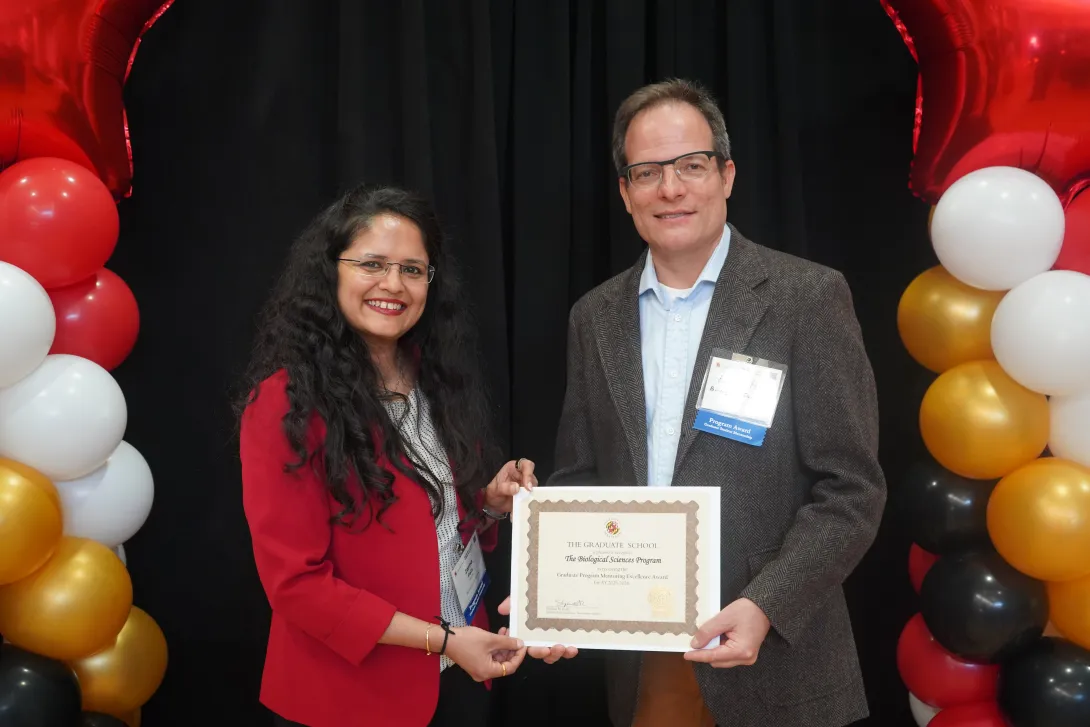 Drs. Zarna Pala and Eric Haag accepting a Graduate School award on behalf of BISI