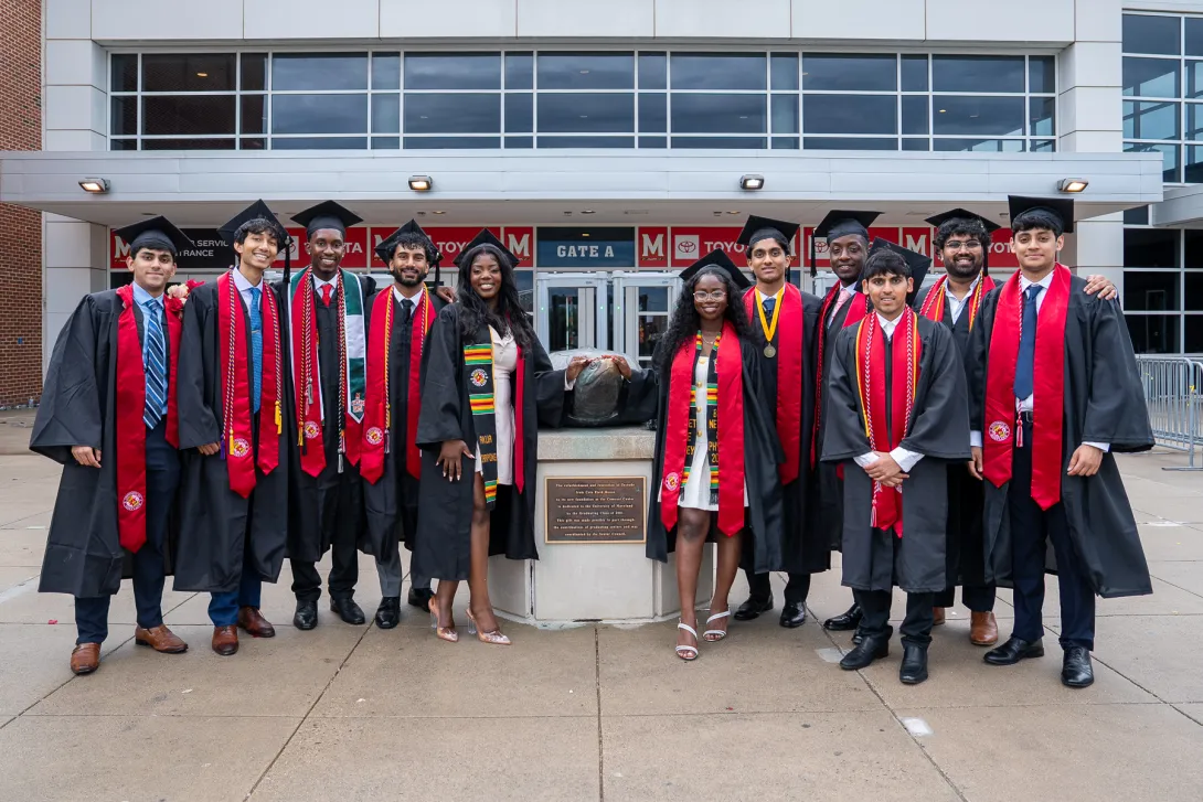 Group of graduates stand next to Testudo outside of the Xfinity Center