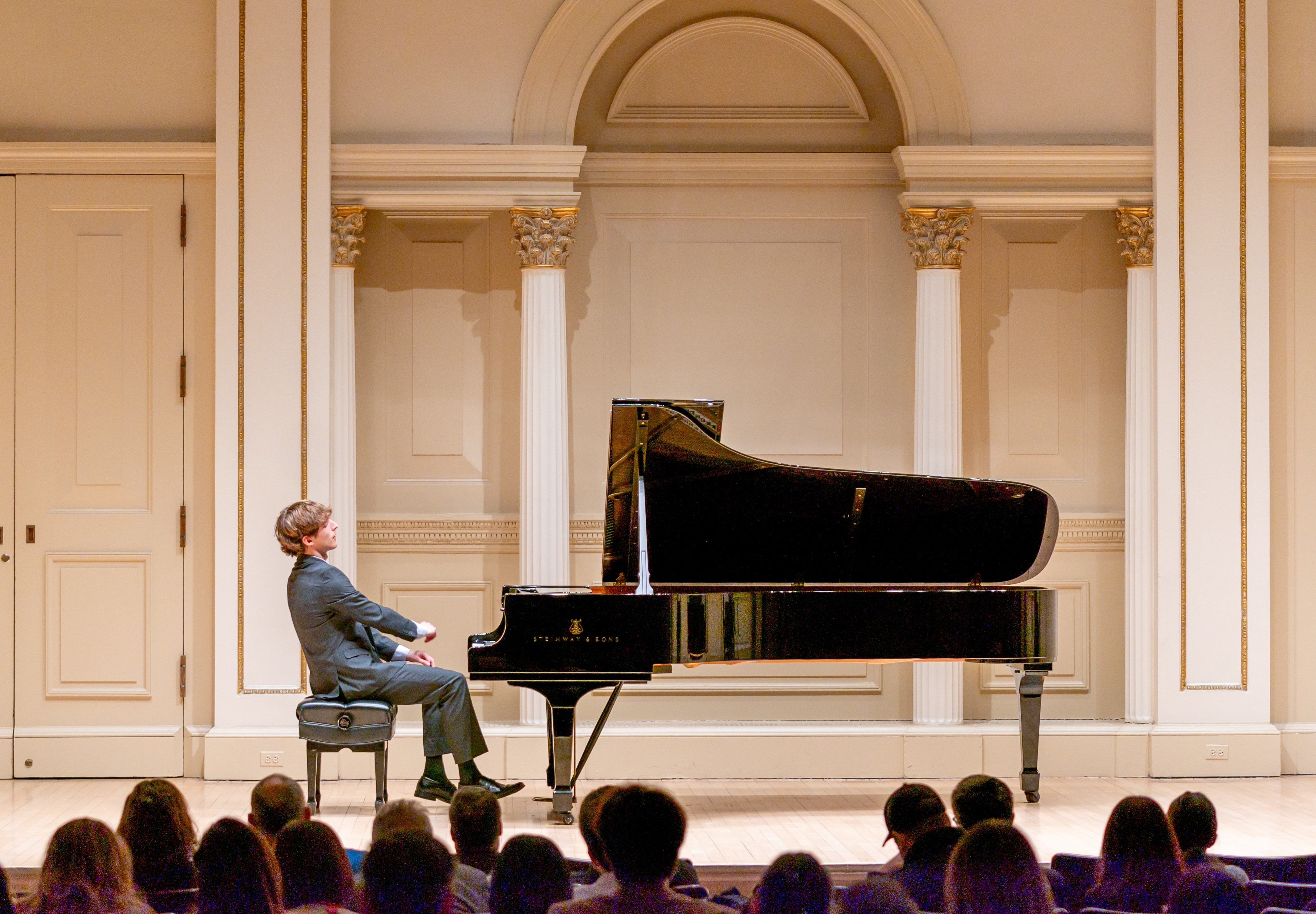 Jacob Goldman at the piano on stage at Carnegie Hall during a student recital.